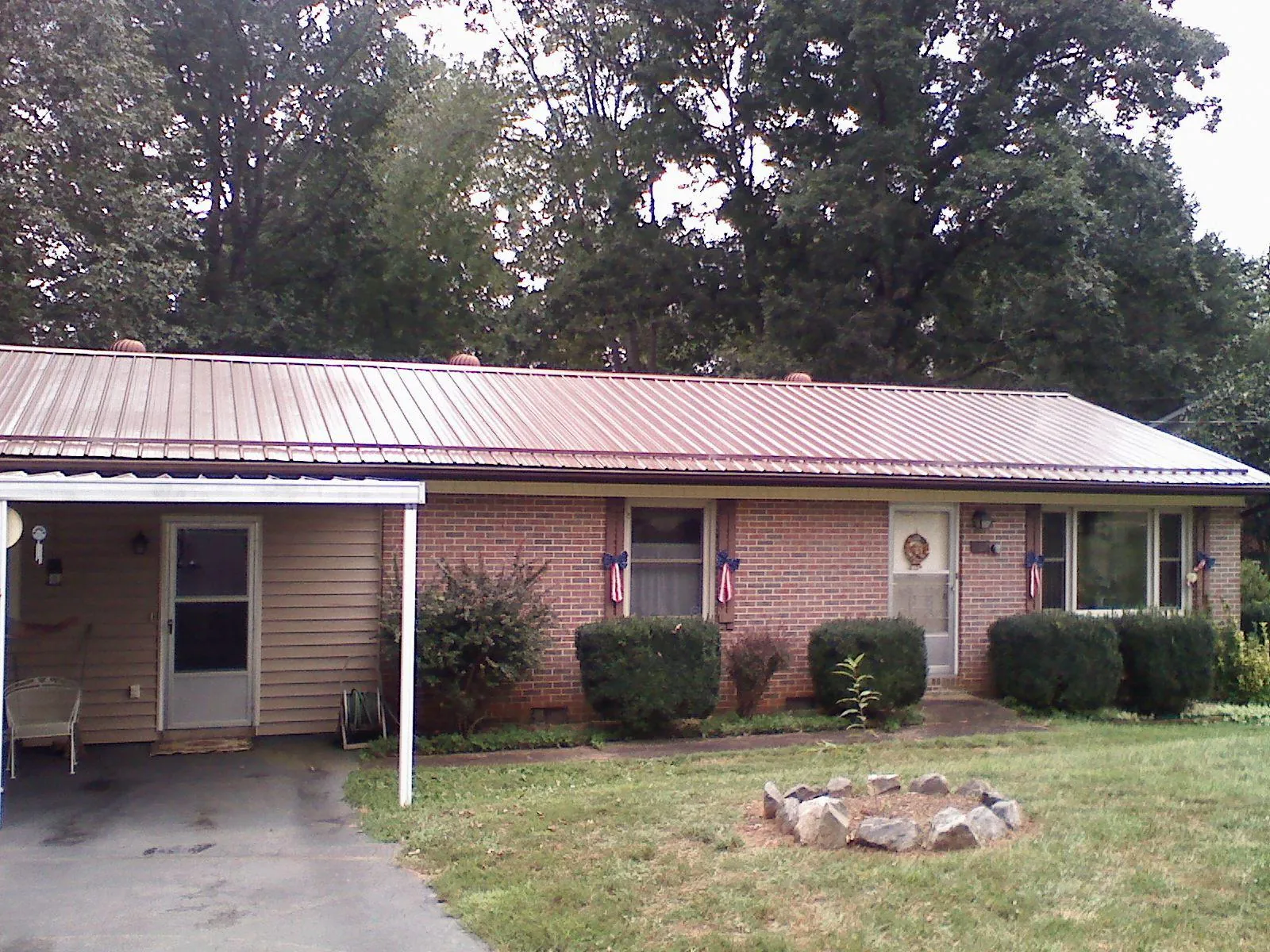 Bronze metal roof and carport on a brick ranch home — Roof Repair work by our crew in Geigertown